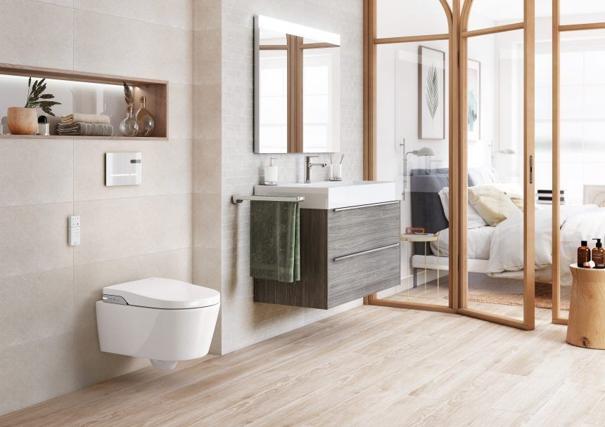 Wall-hung toilet and floating vanity with glass shower door