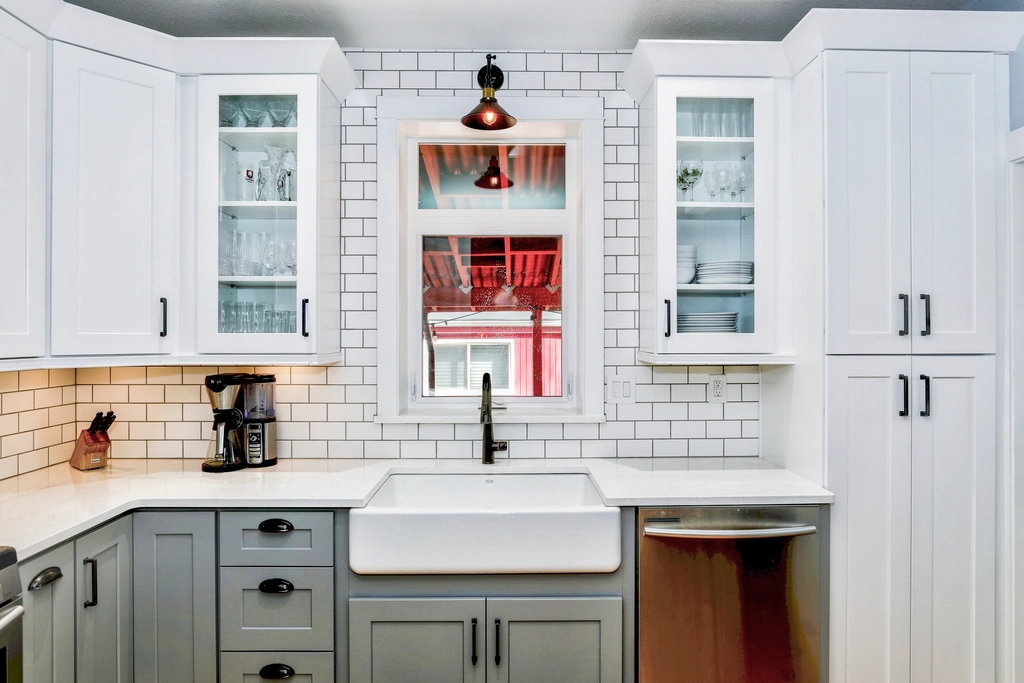 Bright white kitchen remodel with shaker cabinets and farmhouse sink